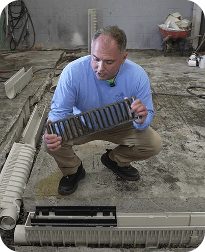 Installer inspecting a removable trench drain grate