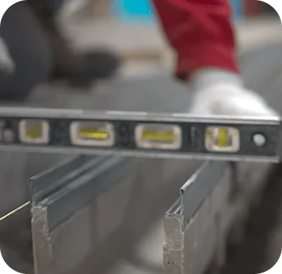 Worker checking the level of a metal drain channel